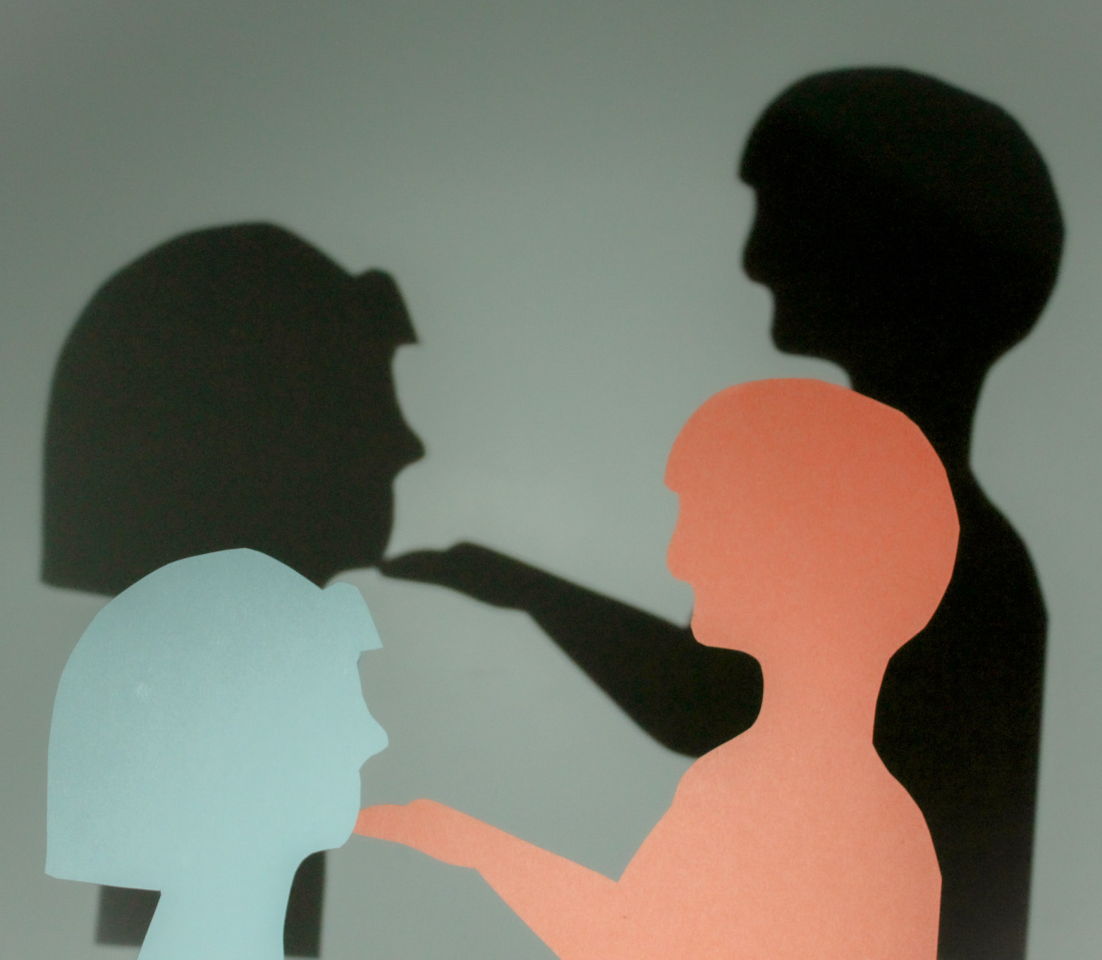 simple illustration of a young feminine figure having their chin held by a masculine older figure, their dark silhouettes behind them.