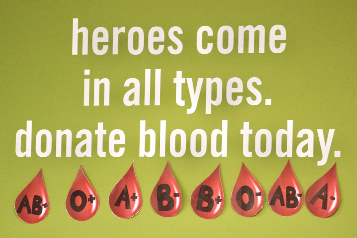 photo of a blood bank sign reading "heroes come in all types, donate blood today"