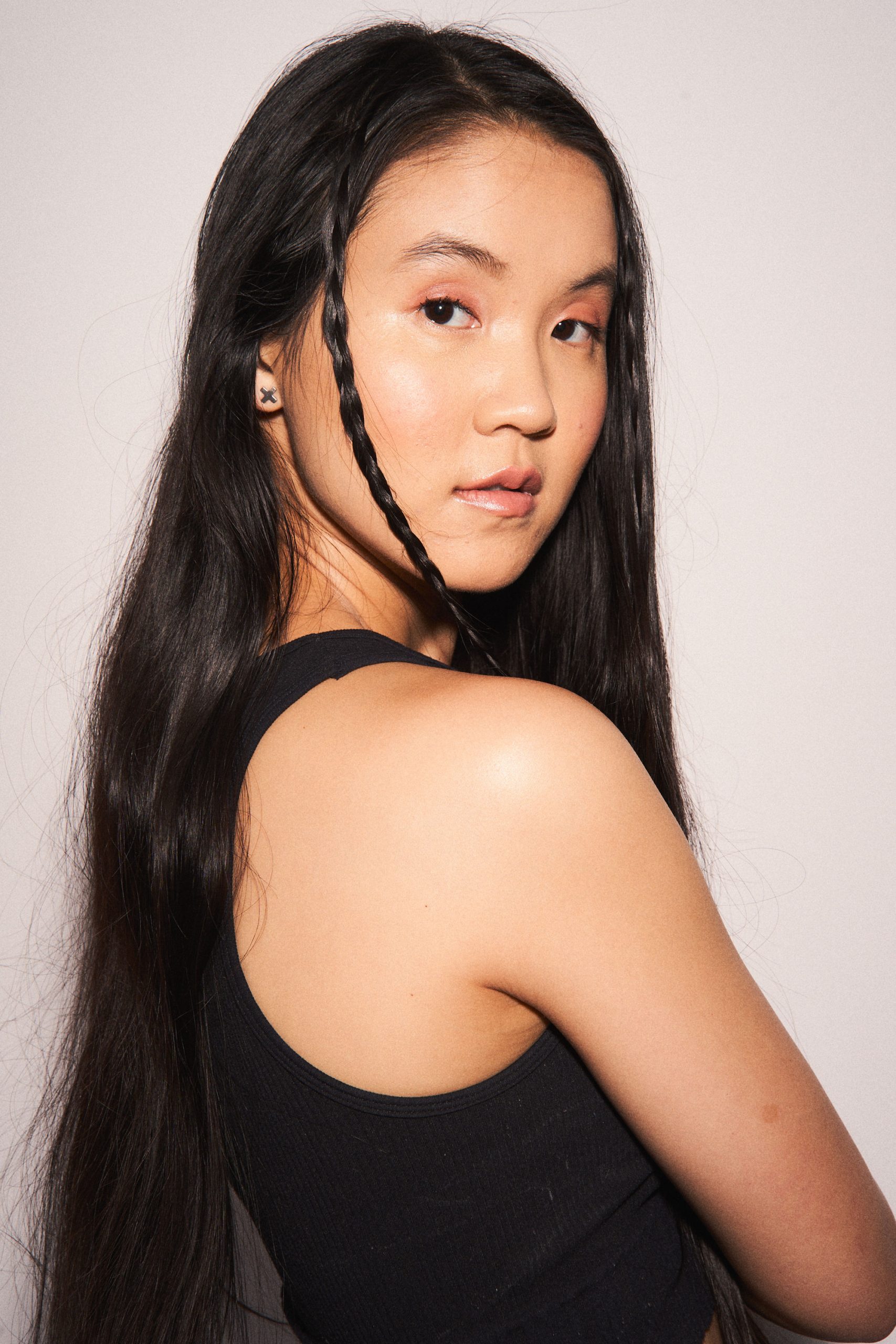 photo of Heather Muriel Nguyen, a Vietnamese American person with straight black hair and a black tank top