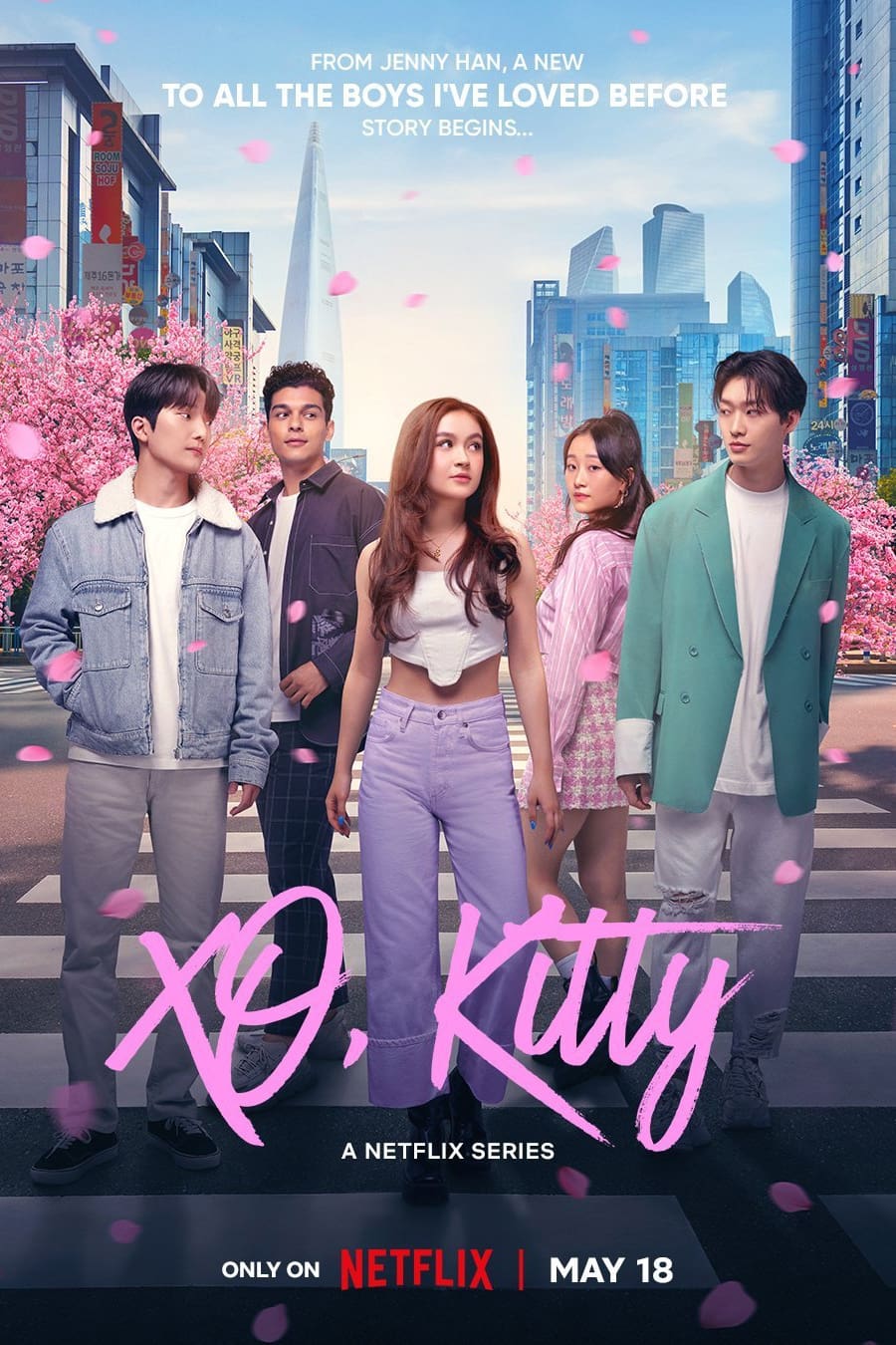 A Netflix poster for "XO, Kitty." Besides the title, it reads, "From Jenny Han, a new 'To All the Boys I've Loved Before' story begins..." and "Only on Netflix | May 18." Five young people stand in front of a city with blooming cherry blossom trees. From left to right, there is a young man with light skin and dark hair in a jean jacket, a young man with light brown skin and dark curls wearing a dark gray shirt, a young woman with light skin and brown hair in a white tanktop, a young woman with light skin and black hair wearing pink, a young man with light skin and black hair wearing a mint jacket.